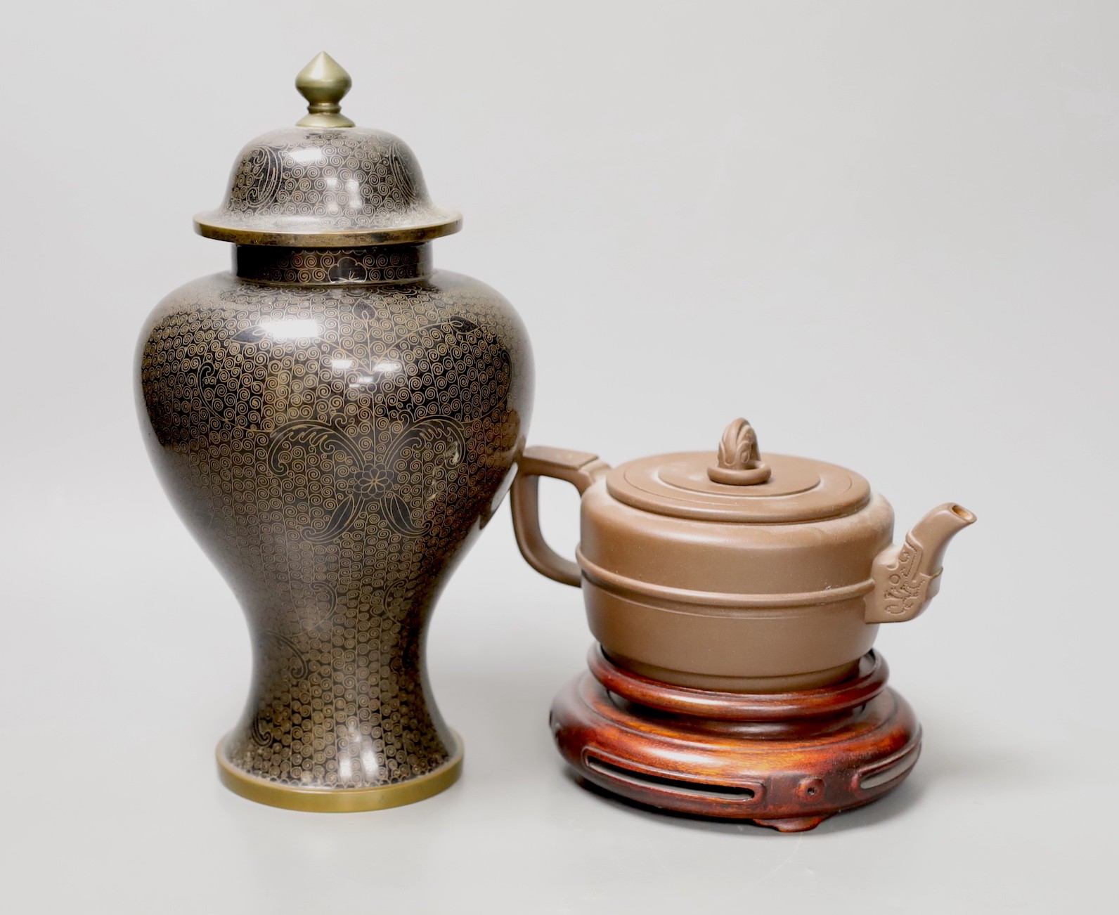 A Chinese cloisonné enamel vase and cover, 25cm tall, and a Chinese Yixing redware teapot